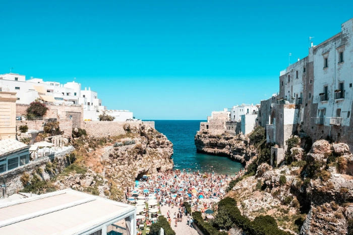 people on beach near buildings during daytime
