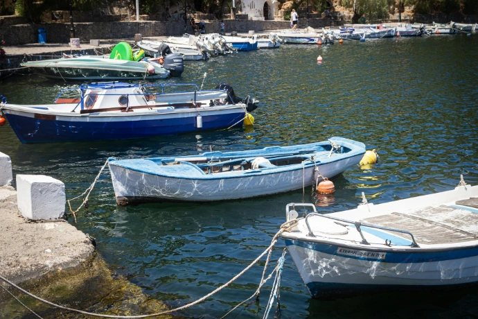 A group of boats floating on top of a body of water